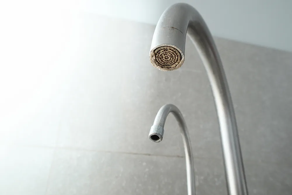 A calcified water tap. Test your drinking water with the water testing kits from IVARIO.