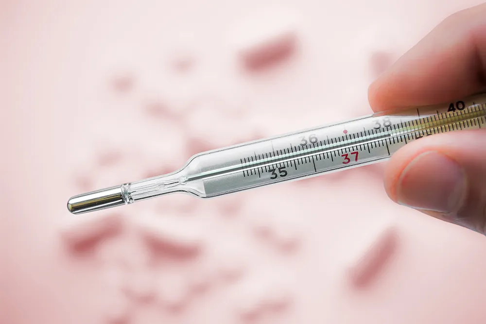 Mercury thermometer which showing 38Celsius. Test your drinking water with the water testing kits from IVARIO.