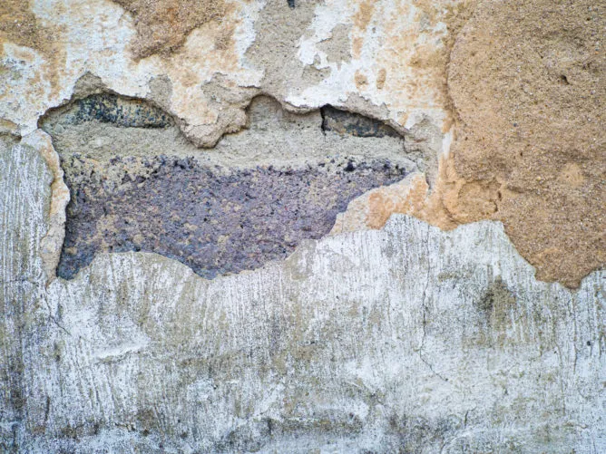 Asbestos can be found in a house's walls, plaster, and ceilings.